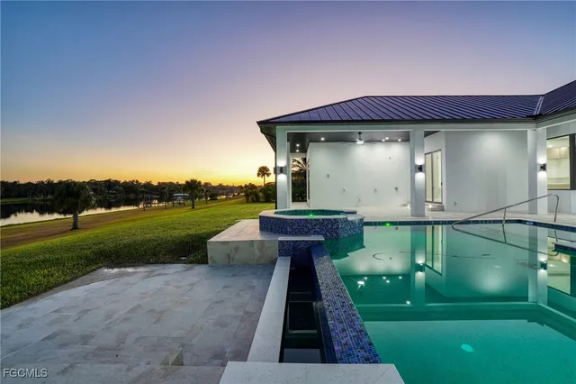 a patio with table and chairs under an umbrella