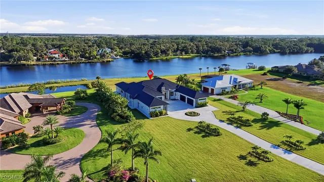 an aerial view of a house with outdoor space pool patio lake and outdoor seating