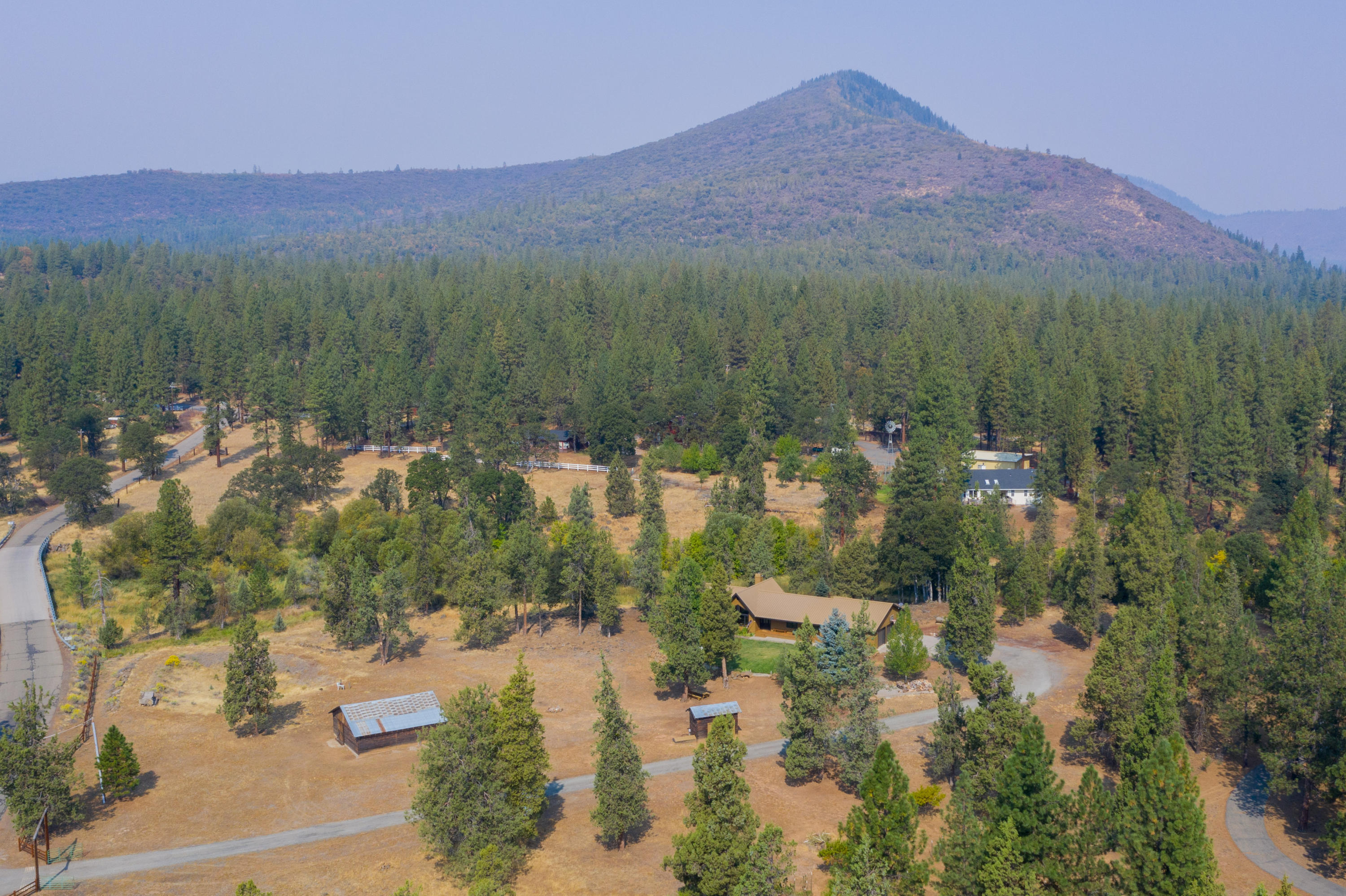 37600 Vedder Road Burney, CA 96013 - Photo 4 of 69 a view of a lake with mountains in the background