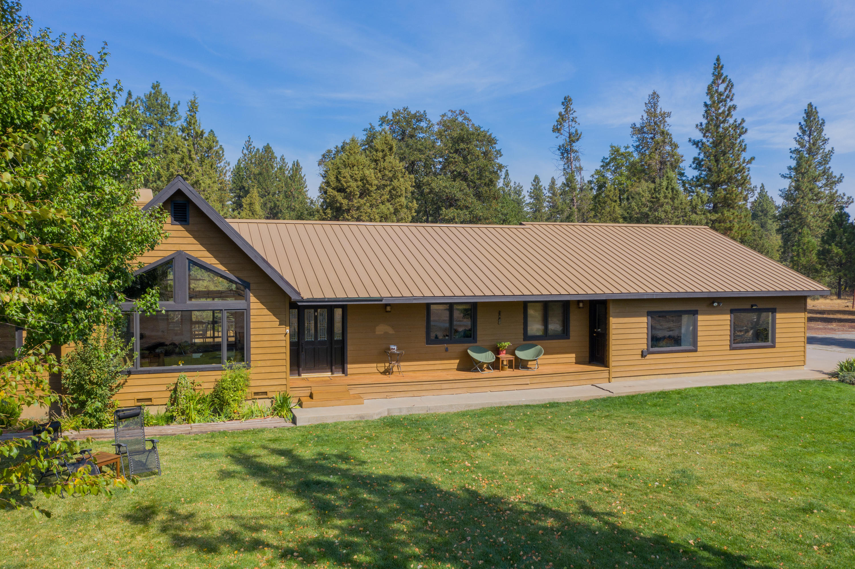 37600 Vedder Road Burney, CA 96013 - Photo 60 of 69 a backyard of a house with garden and outdoor seating