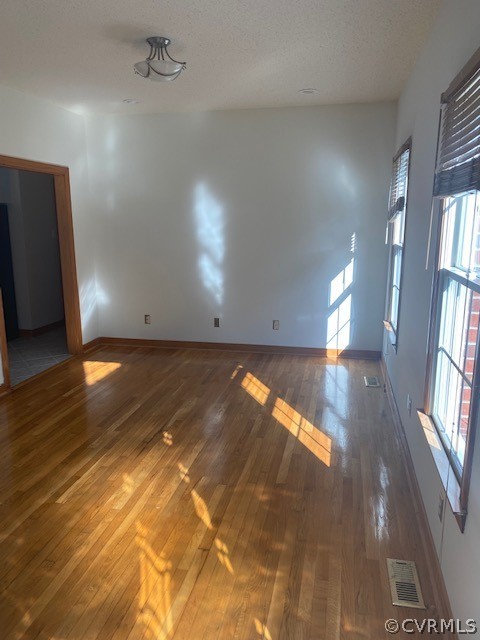 18630 Templeton Road Disputanta, VA 23842 - Photo 4 of 41 an empty room with wooden floor and windows