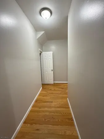 en empty room with wooden floor