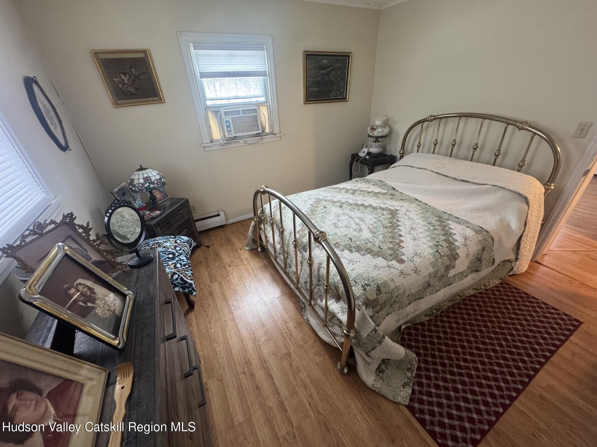 107 Route 40 Road Hensonville, NY 12439 - Photo 12 of 22 a bedroom with a bed and wooden floor