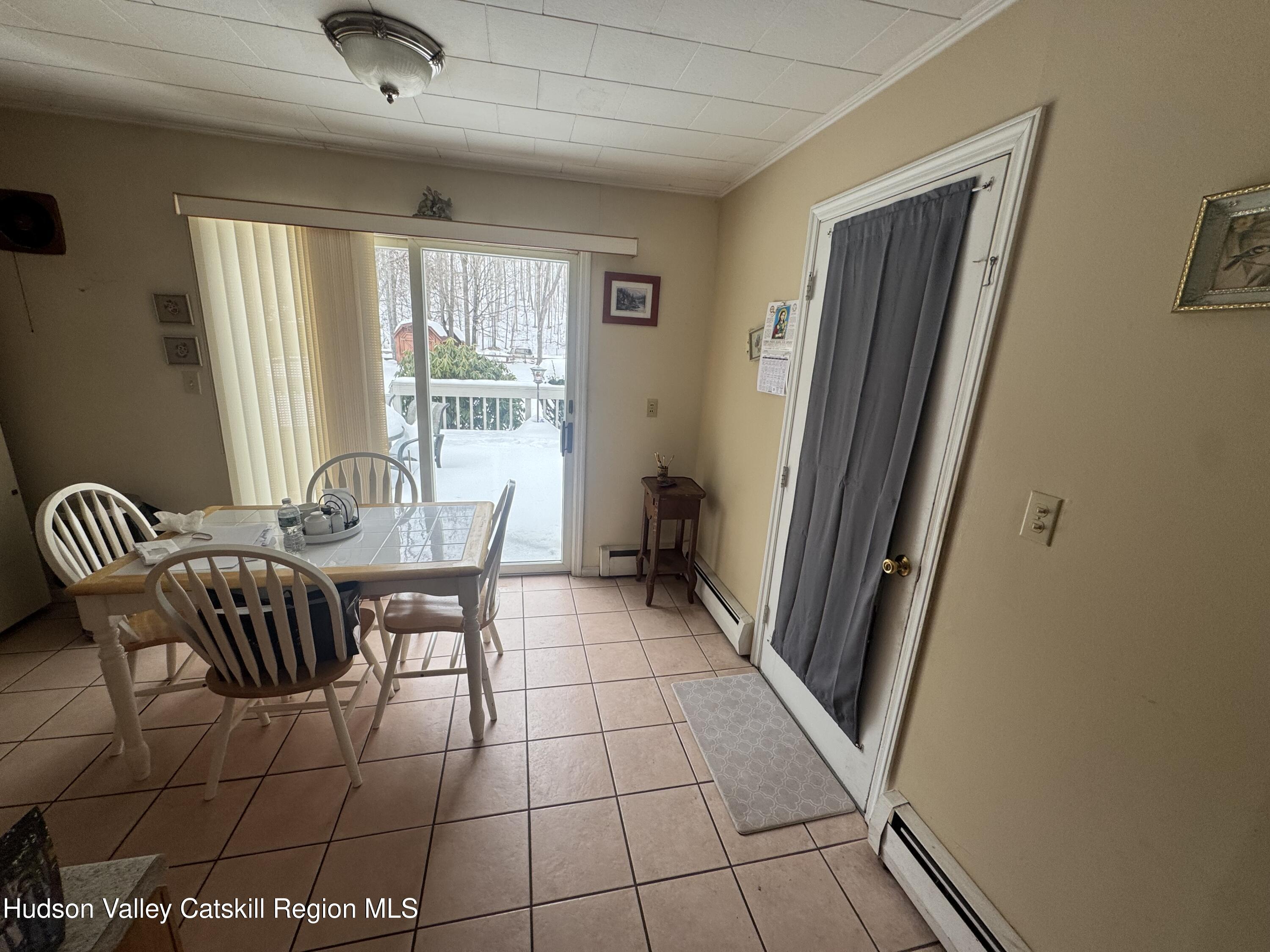 107 Route 40 Road Hensonville, NY 12439 - Photo 8 of 22 a dining room with furniture and large windows