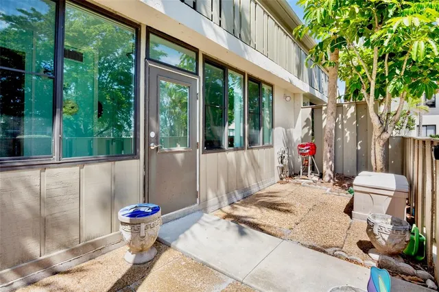 a building outdoor space with patio furniture and potted plants