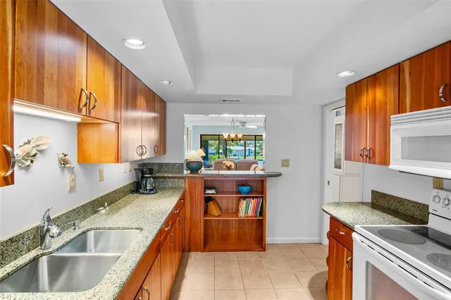 a kitchen with stainless steel appliances granite countertop sink stove and cabinets