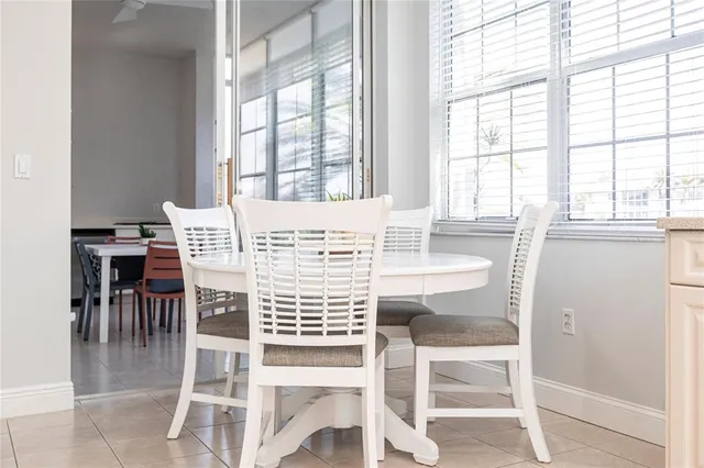 a view of a dining room with furniture and a large window