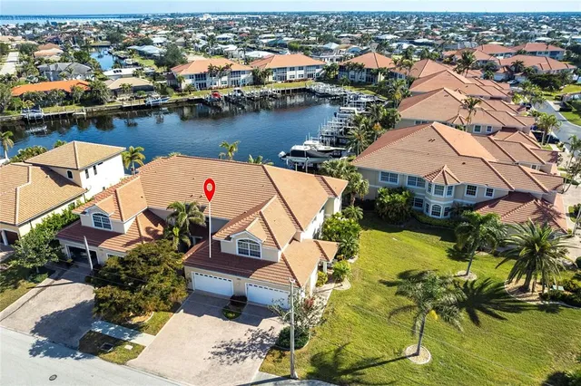 an aerial view of residential houses with outdoor space and lake view
