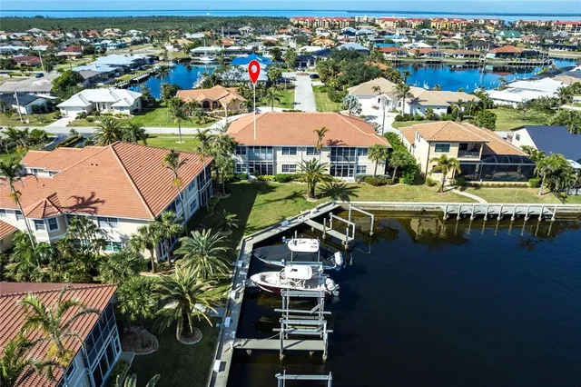an aerial view of residential houses with outdoor space and swimming pool