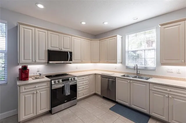 a kitchen that has a sink and a stove in it