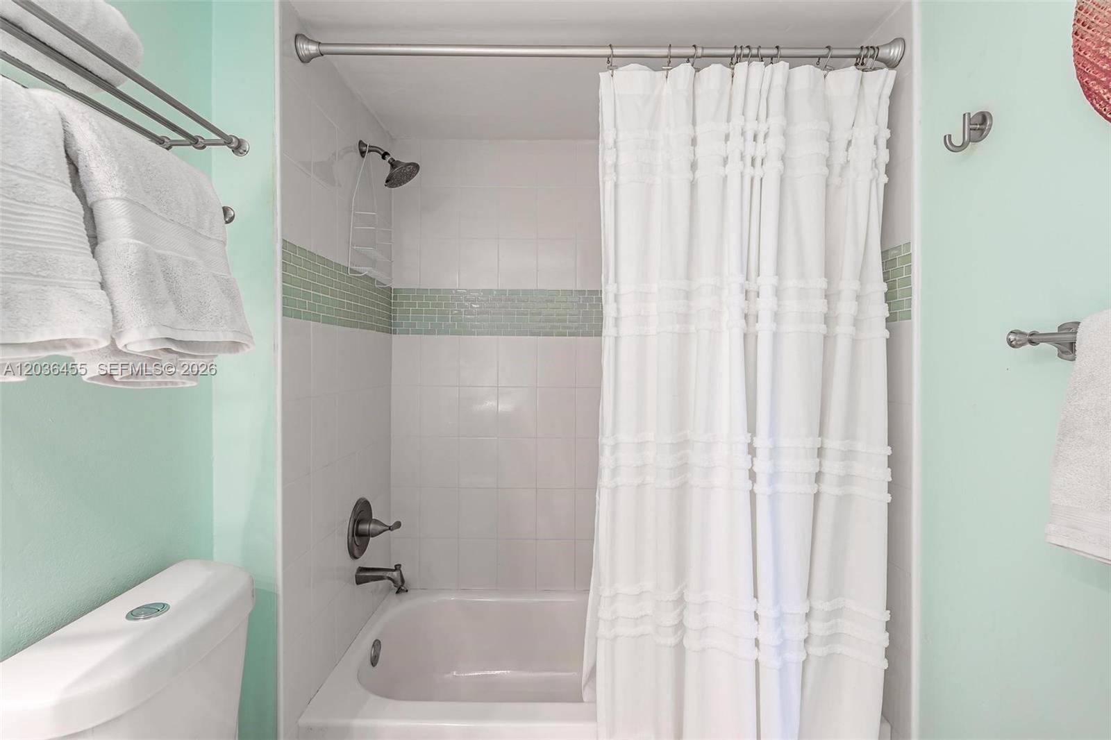 780 Northeast 69th Street, Unit 1010 Miami, FL 33138 - Photo 26 of 31 a bathroom with a shower and a toilet