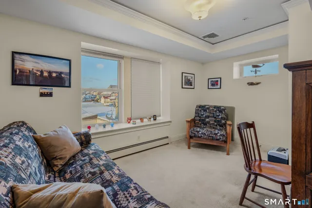 a bedroom with furniture and a window