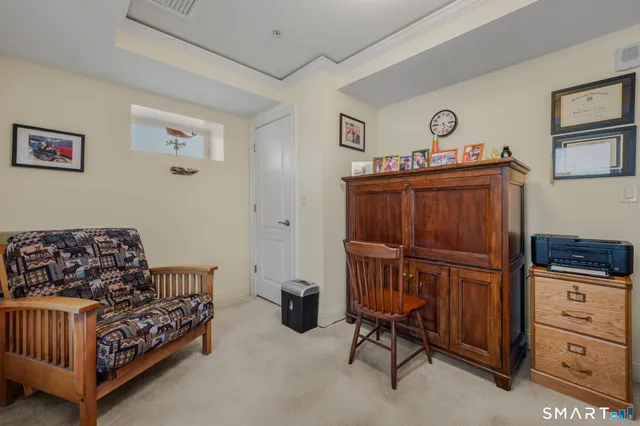 a bedroom with furniture and a baby crib