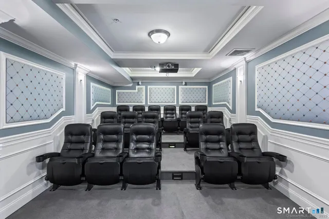 a media room with lots of chairs and mirrors