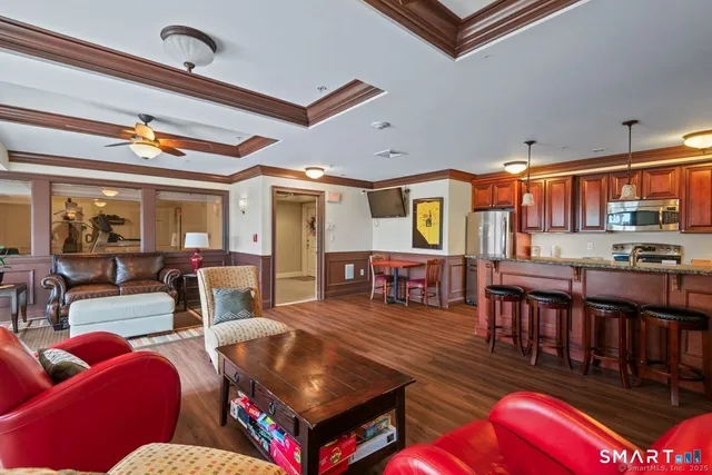 a living room with lots of furniture and a large window