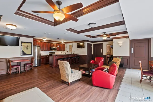 a living room with furniture and kitchen view