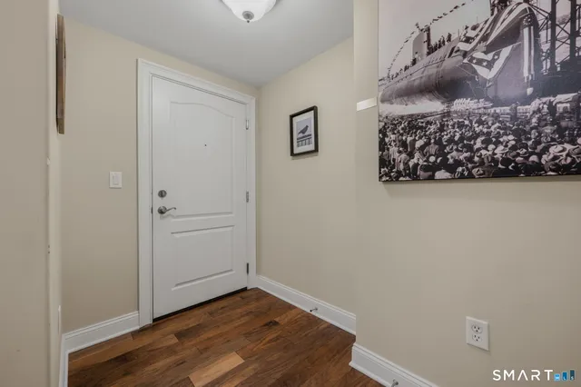 a view of a room with wooden floor