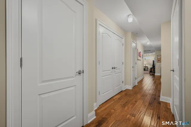 a view of a hallway with wooden floor