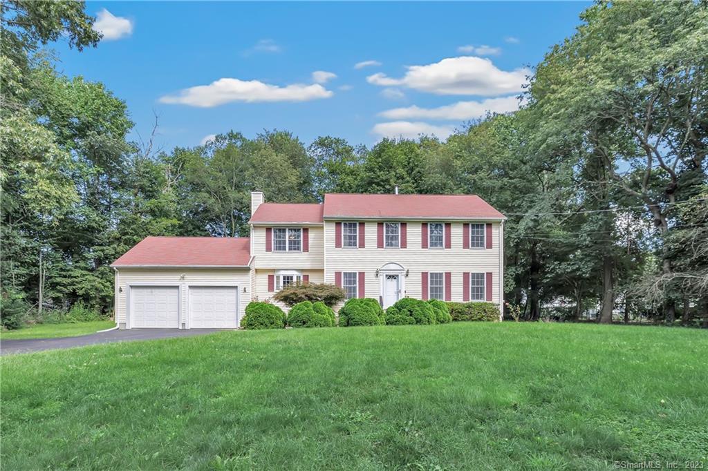 a aerial view of a house with yard and green space