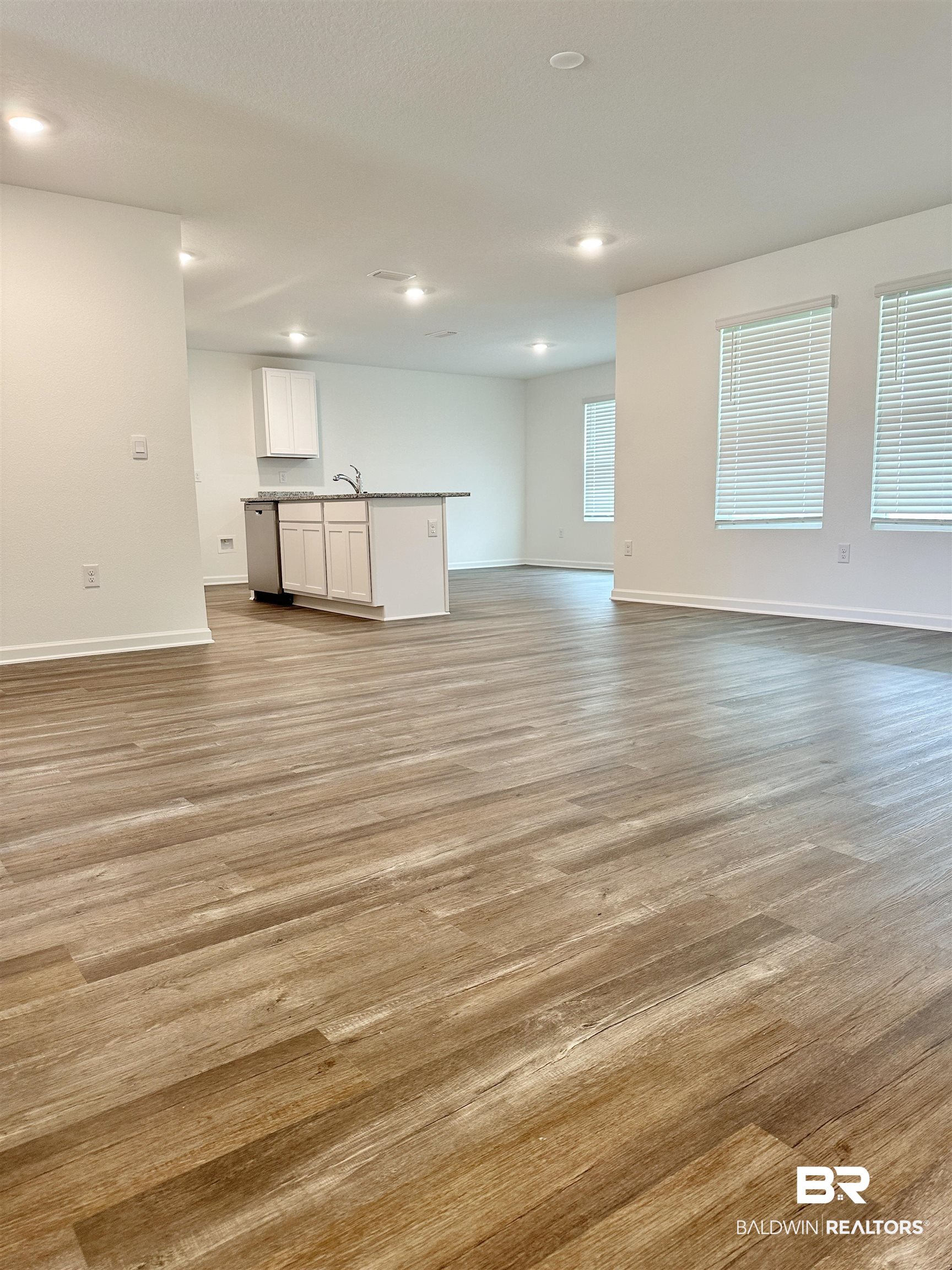 22275 Aleutian Avenue Foley, AL 36535 - Photo 9 of 72 Unfurnished living room featuring sink and light hardwood / wood-style flooring