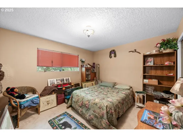 a living room with furniture a large window and a table