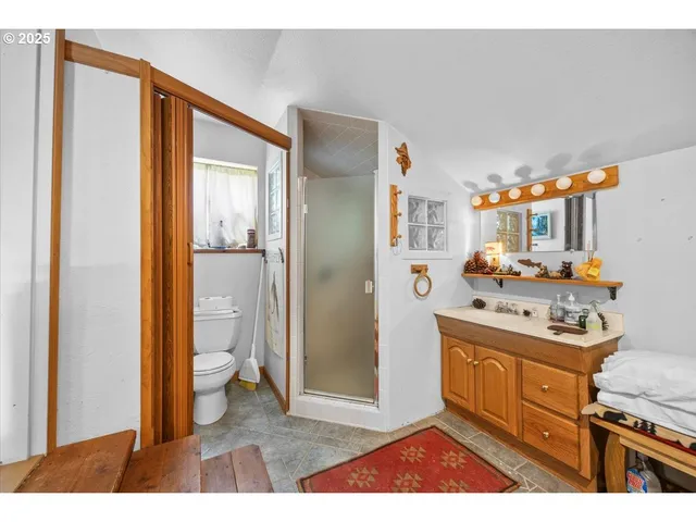 a bedroom with a bed and a flat tv screen on dresser