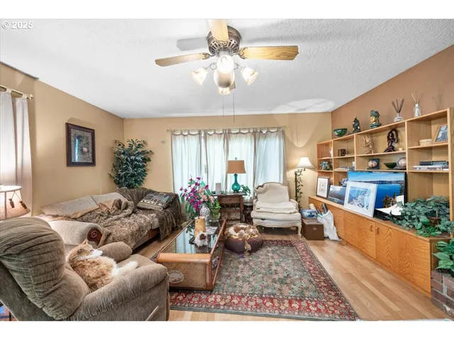a living room with furniture window and wooden floor