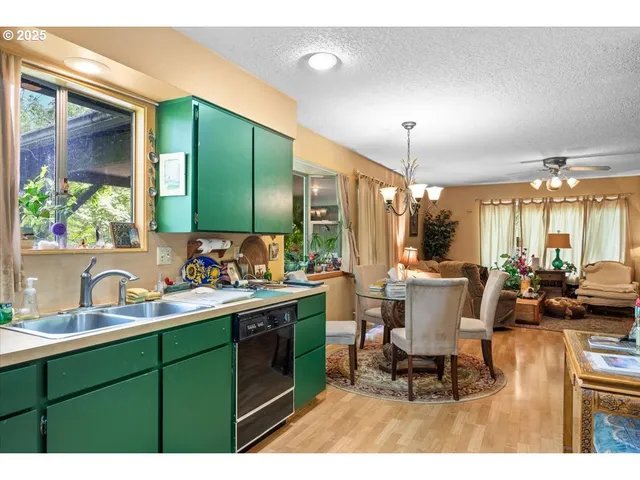 a kitchen with a sink dining table and chairs