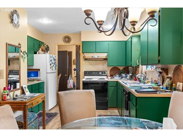 a kitchen with a sink cabinets and stainless steel appliances