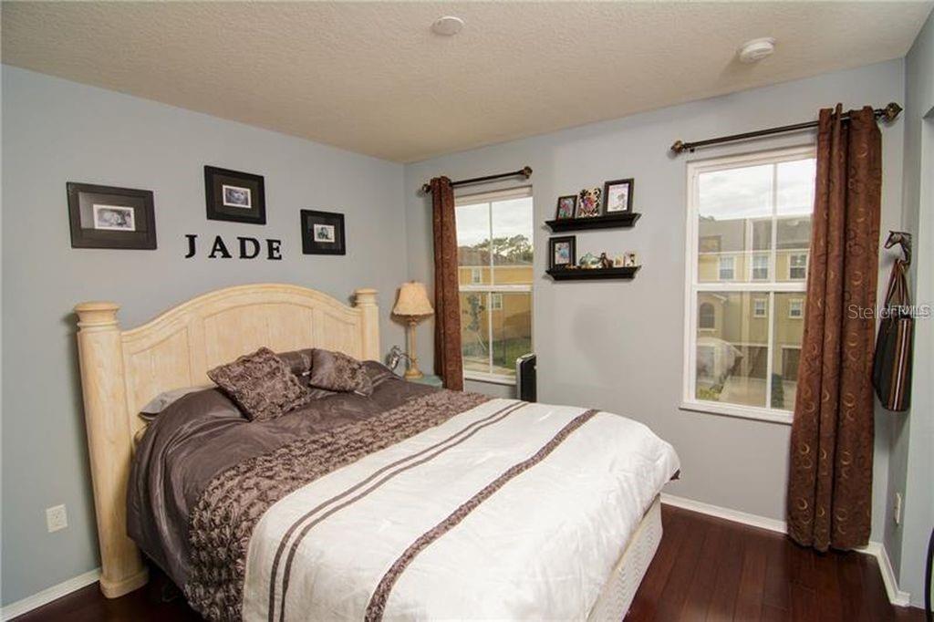 8946 White Sage Loop Lakewood Ranch, FL 34202 - Photo 27 of 36 a bedroom with a large bed and a window