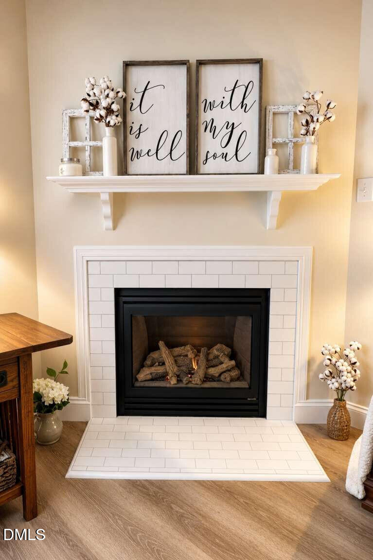 120 Student Place Durham, NC 27713 - Photo 5 of 15 a living room with a fireplace and a chandelier