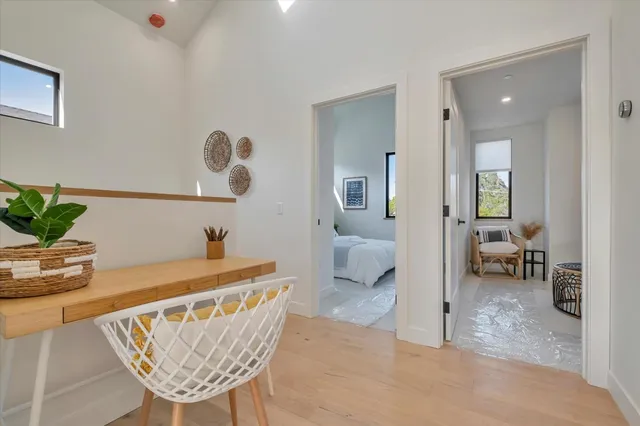 a dining room with furniture and a potted plant