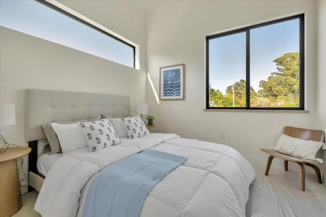 a bedroom with a bed and painting on the wall