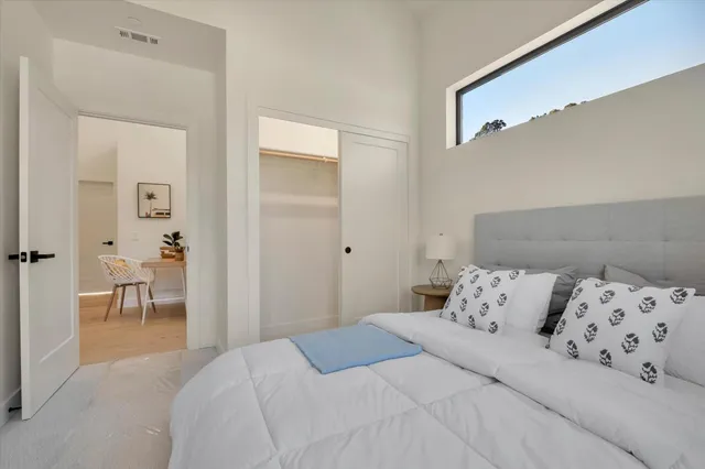 a bedroom with a bed and a mirror