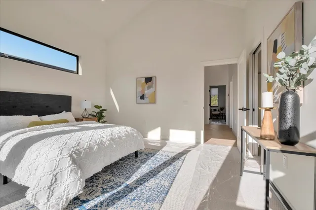 a bedroom with bed and a potted plant