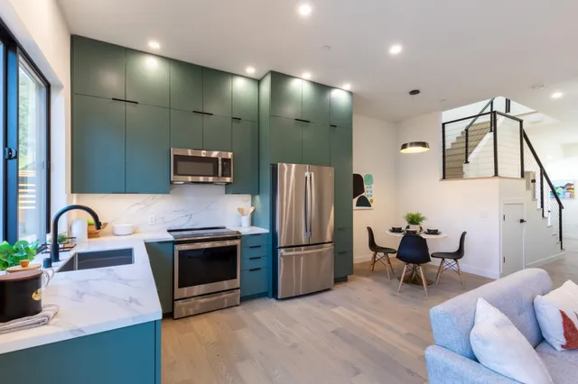 a kitchen with stainless steel appliances granite countertop a refrigerator sink and stove