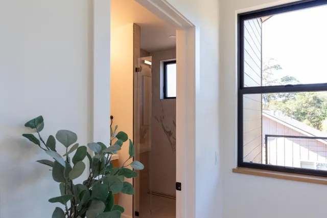 a bedroom with a bed and a potted plant