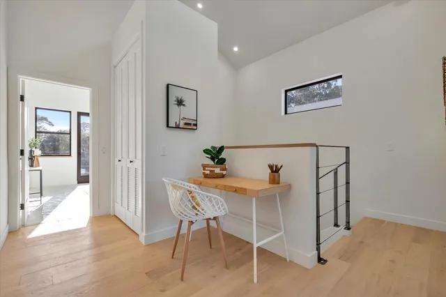 a view of a room with furniture and wooden floor