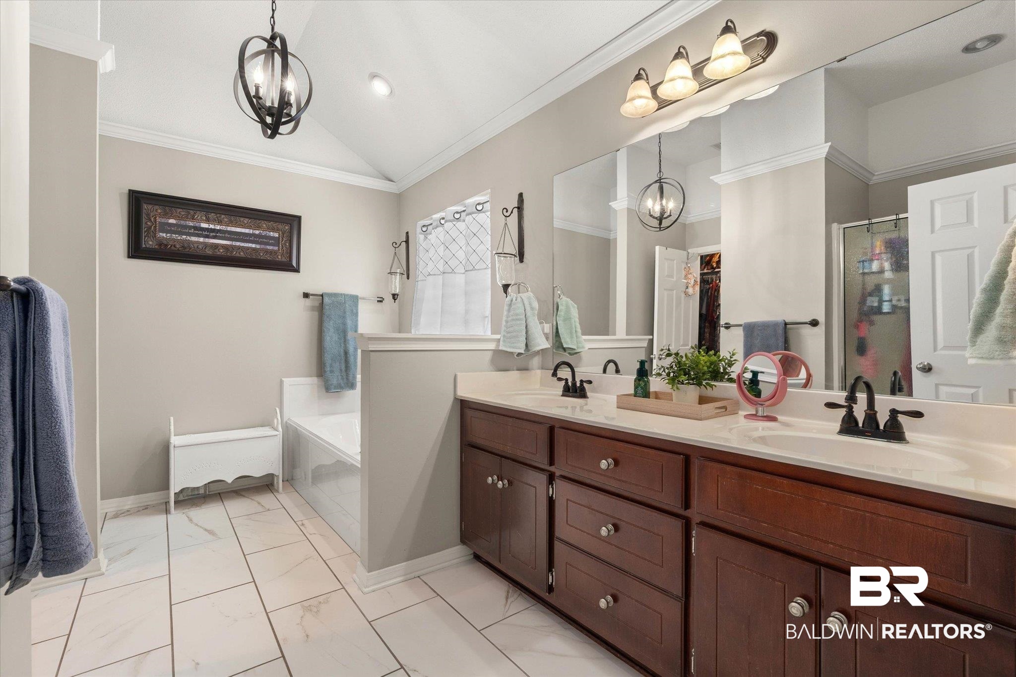 8600 Sable Court Semmes, AL 36575 - Photo 11 of 20 Bathroom featuring a chandelier, double vanity, a bath, a shower stall, and lofted ceiling