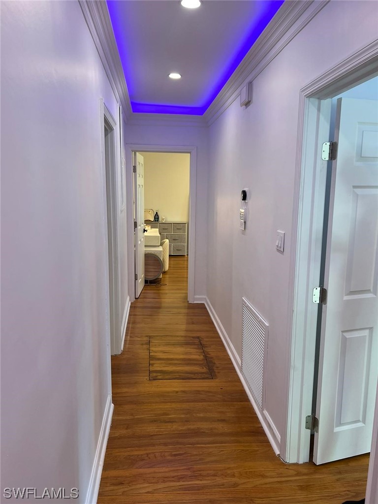 1337 Bradford Road Fort Myers, FL 33901 - Photo 18 of 46 a view of a hallway with wooden floor and a bathroom