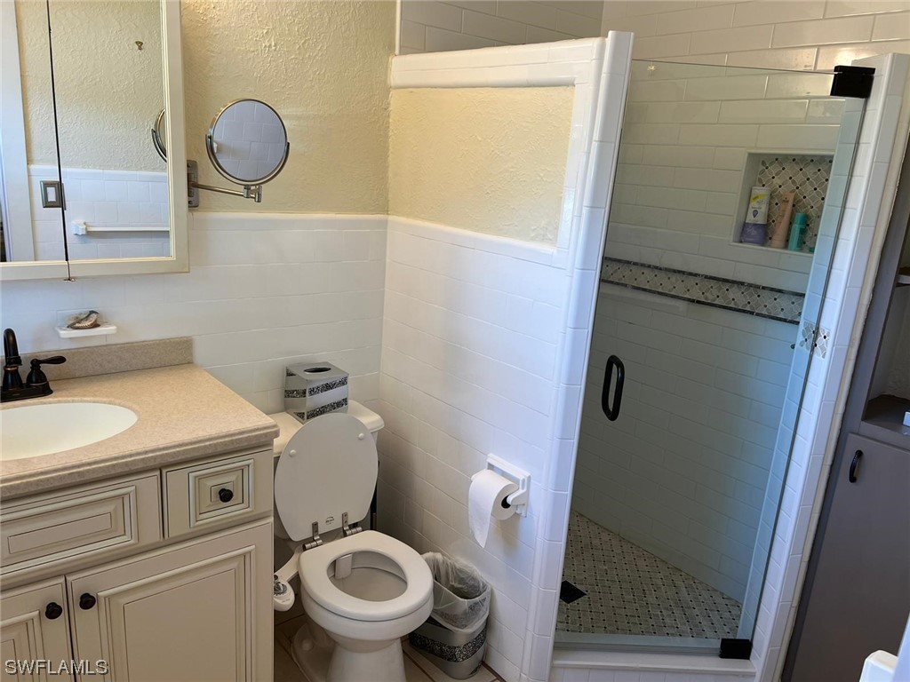 1337 Bradford Road Fort Myers, FL 33901 - Photo 26 of 46 a bathroom with a toilet sink and mirror