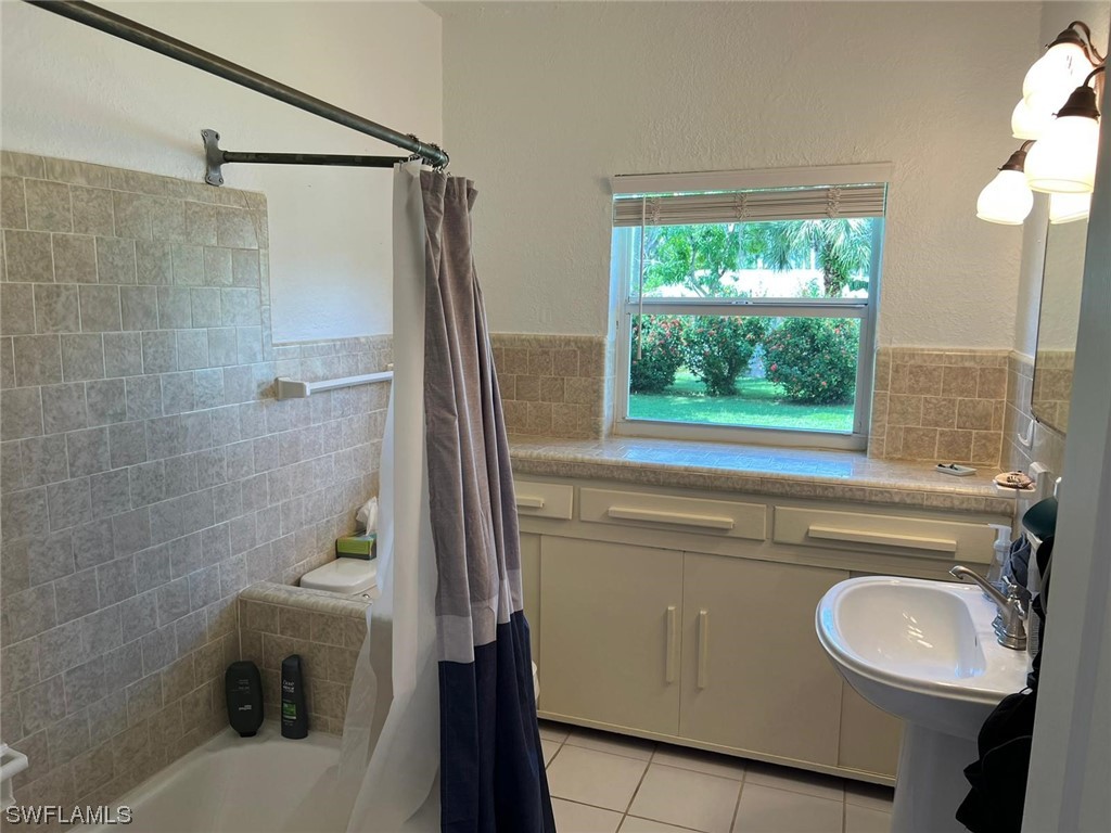 1337 Bradford Road Fort Myers, FL 33901 - Photo 28 of 46 a bathroom with a sink a toilet a window and vanity