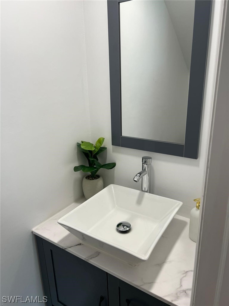 1337 Bradford Road Fort Myers, FL 33901 - Photo 29 of 46 a bathroom with a sink and a mirror