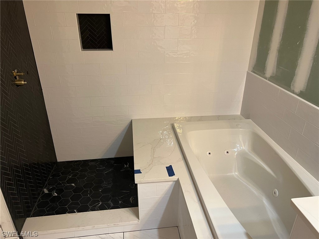 1337 Bradford Road Fort Myers, FL 33901 - Photo 30 of 46 a bathroom with a bathtub and a shower