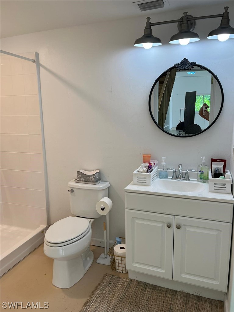 1337 Bradford Road Fort Myers, FL 33901 - Photo 35 of 46 a bathroom with a toilet a sink and mirror