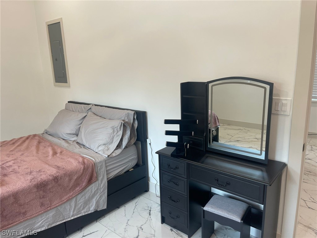 1337 Bradford Road Fort Myers, FL 33901 - Photo 40 of 46 a bedroom with a bed a mirror and a desk