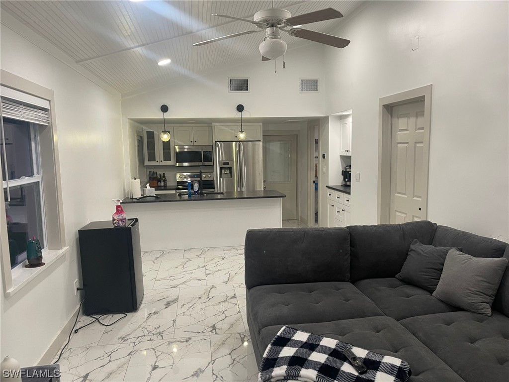 1337 Bradford Road Fort Myers, FL 33901 - Photo 42 of 46 a living room with furniture and kitchen view