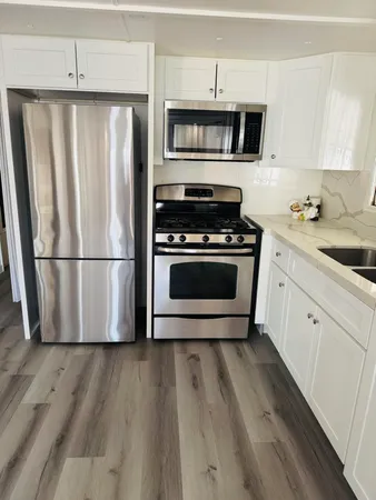 a kitchen with wooden cabinets and stainless steel appliances