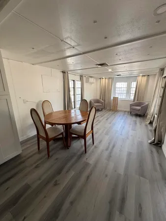 a view of a dining room with furniture and window