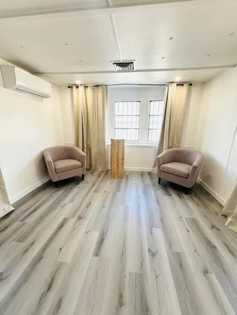 a living room with furniture and a window